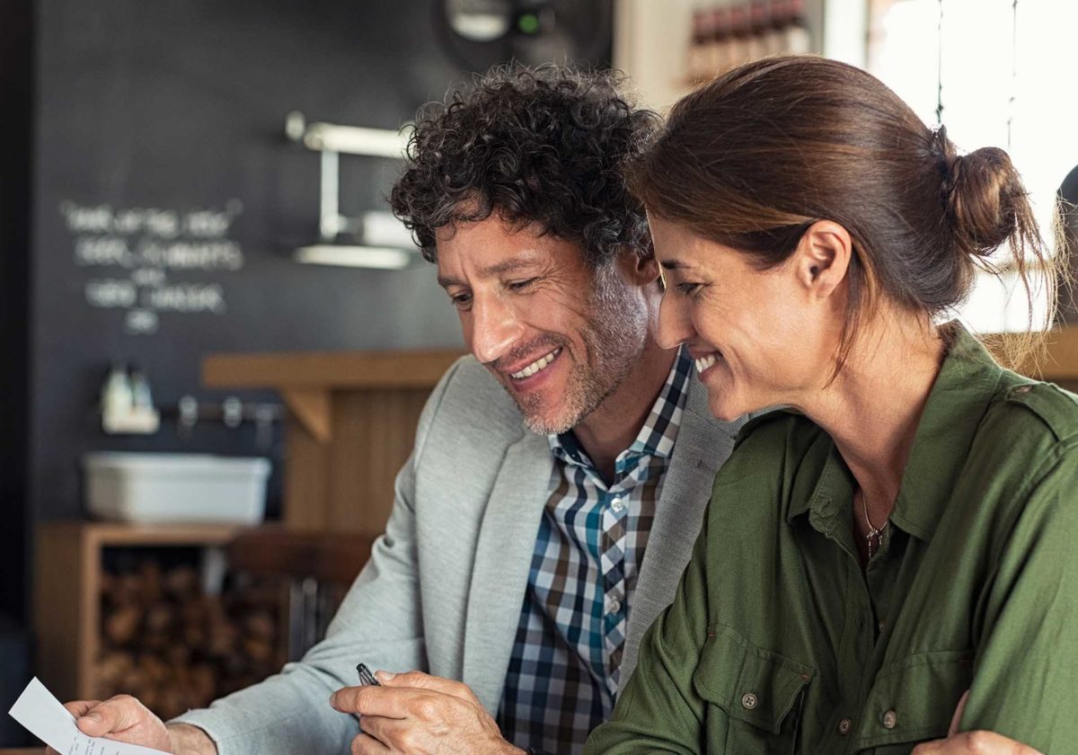 A couple at a cafe considers their debt relief options